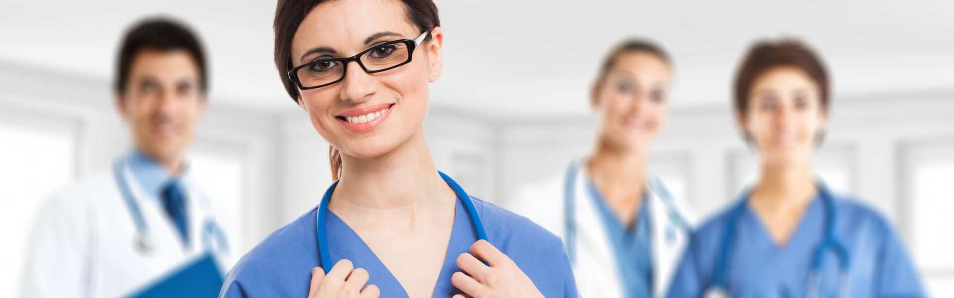 smiling nurse in front of her medical team